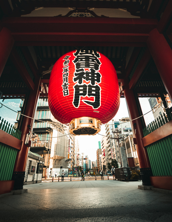 Traditional Asian lantern hanging inside gate of old shrine